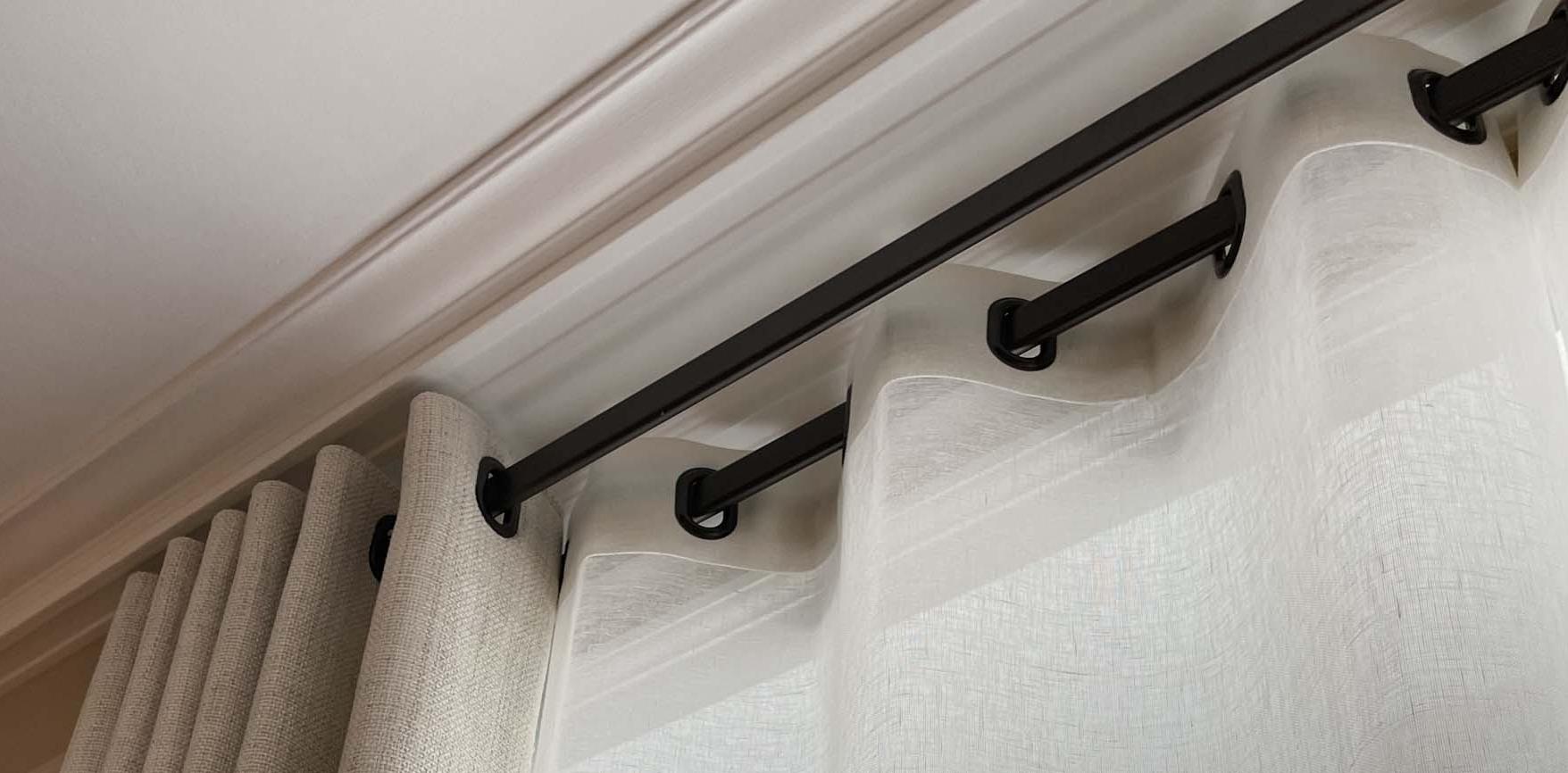 Double flat rod with curtains and sheers with oblong eyelets.